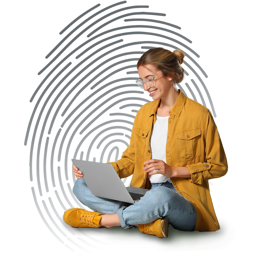 A woman sitting on the floor working on her laptop. She is being protected by Cisco Duo.